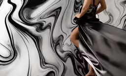 the woman is wearing a black dress and high heels