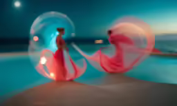 a woman with long hair wearing a pink dress