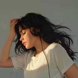 a girl with long hair standing in a white room