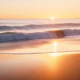 the sun is setting over the ocean waves