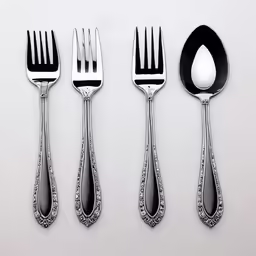 the forks and spoons have ornate silver designs
