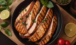 slices of meat with garnish on a plate