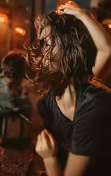 a woman is brushing her long hair