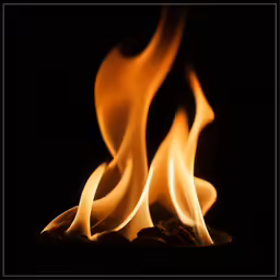 a pair of flames are lit in the dark