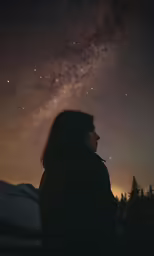 a person looking up at the night sky