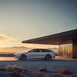 a car parked outside of a building with sunset