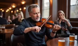 a man that is playing a violin next to some people