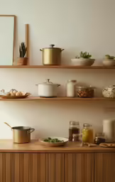 the top shelves in a kitchen are filled with bowls of food