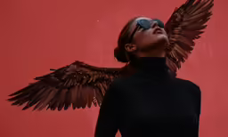 a woman with sunglasses and wings on her face