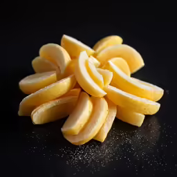 a pile of cut up and unpeeled bananas