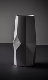 a black vase on a table with the word i and logo in front