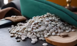 beans are on the wooden table next to a remote control
