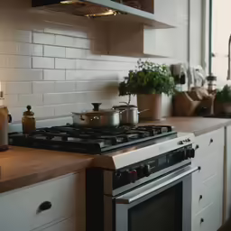 a kitchen with an oven, stove, and pots