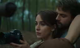 the man and woman are taking photos together
