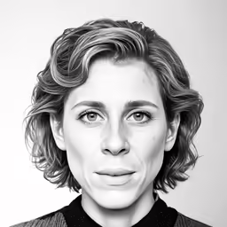 a woman with curly hair is looking at the camera