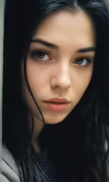 there is a young woman with a long dark hair and large brown eyes