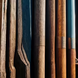 multiple pairs of old baseball bats hanging in rows