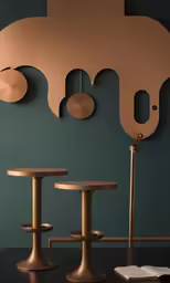 brass furniture, like these pedestals and stools, feature unique sculptural shapes
