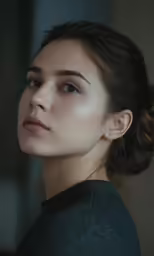 a woman with brown eyes and black top