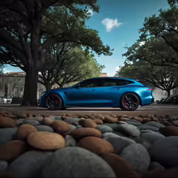 a car sits parked near some rocks and trees