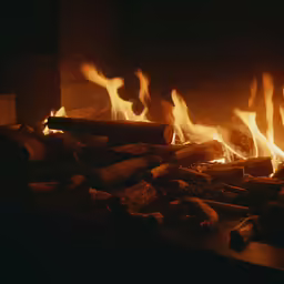 the flames are lit in a fireplace and it looks like they are blazing