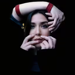 a woman with red and white stockings covering her face