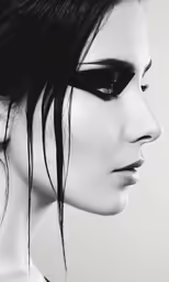 the woman has long dark hair and black eyeliners