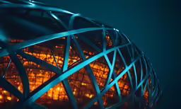 the illuminated steel mesh of a sphere on a dark blue background