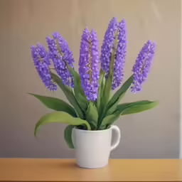 a coffee cup with some purple flowers sitting in it