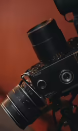 a camera on a tripod set up on a brown background