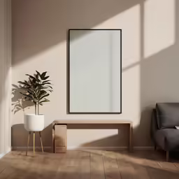 there is a plant in a white pot and a blank picture
