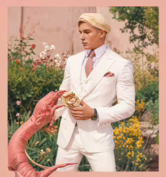 a man in a white suit and tie holds a dragon statue,a man wearing a white suit next to a pink flamingo