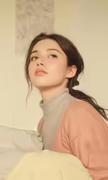 a girl sitting on the bed with her head on the pillows