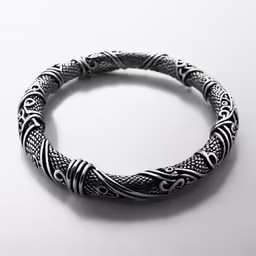 a bracelet on a white background with a silver snake pattern