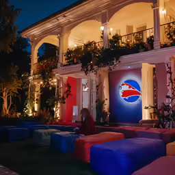 some giant colorful pillows in front of a house