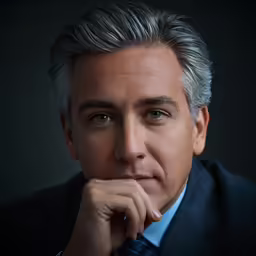 the man in a suit is posing for the camera