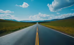 a long empty country road leading into the mountains