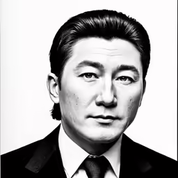 a black and white portrait of a man in suit and tie