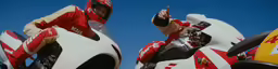 a couple of people on two motorcycles, one holding up