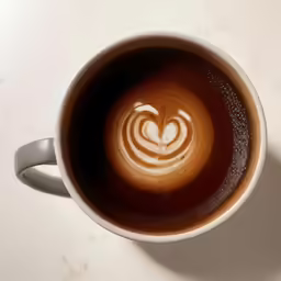 there is a cup of coffee with an intricate design
