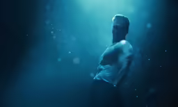 a man standing with his hands behind his back