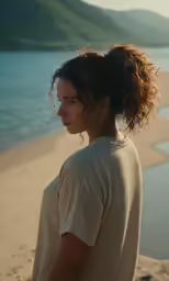 a man is standing at the beach with his head tilted