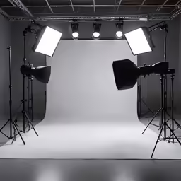 three lights set up in front of a light room