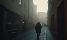 the lone man in the long coat walks down an alley