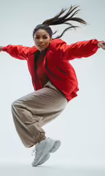 woman in an red jacket and tan pants