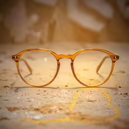 an old pair of glasses resting on the ground