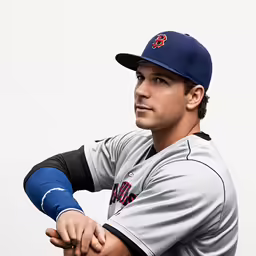 a professional baseball player standing with his hand on the shoulder