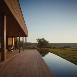 a deck overlooking water and grassy field is shown