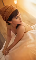 a woman in white dress posing on the bed