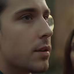 a young man and woman facing away from the camera